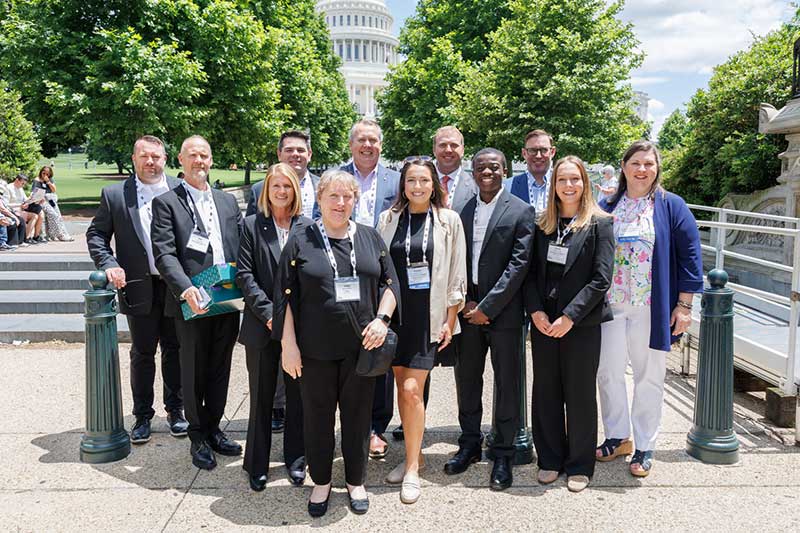 Attendees pose in front of the U.S. Capital.