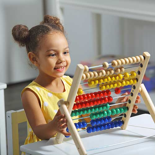 Small girl plays in preschool.